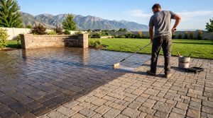 Half-sealed paver patio in Utah showing the color contrast between sealed and unsealed pavers